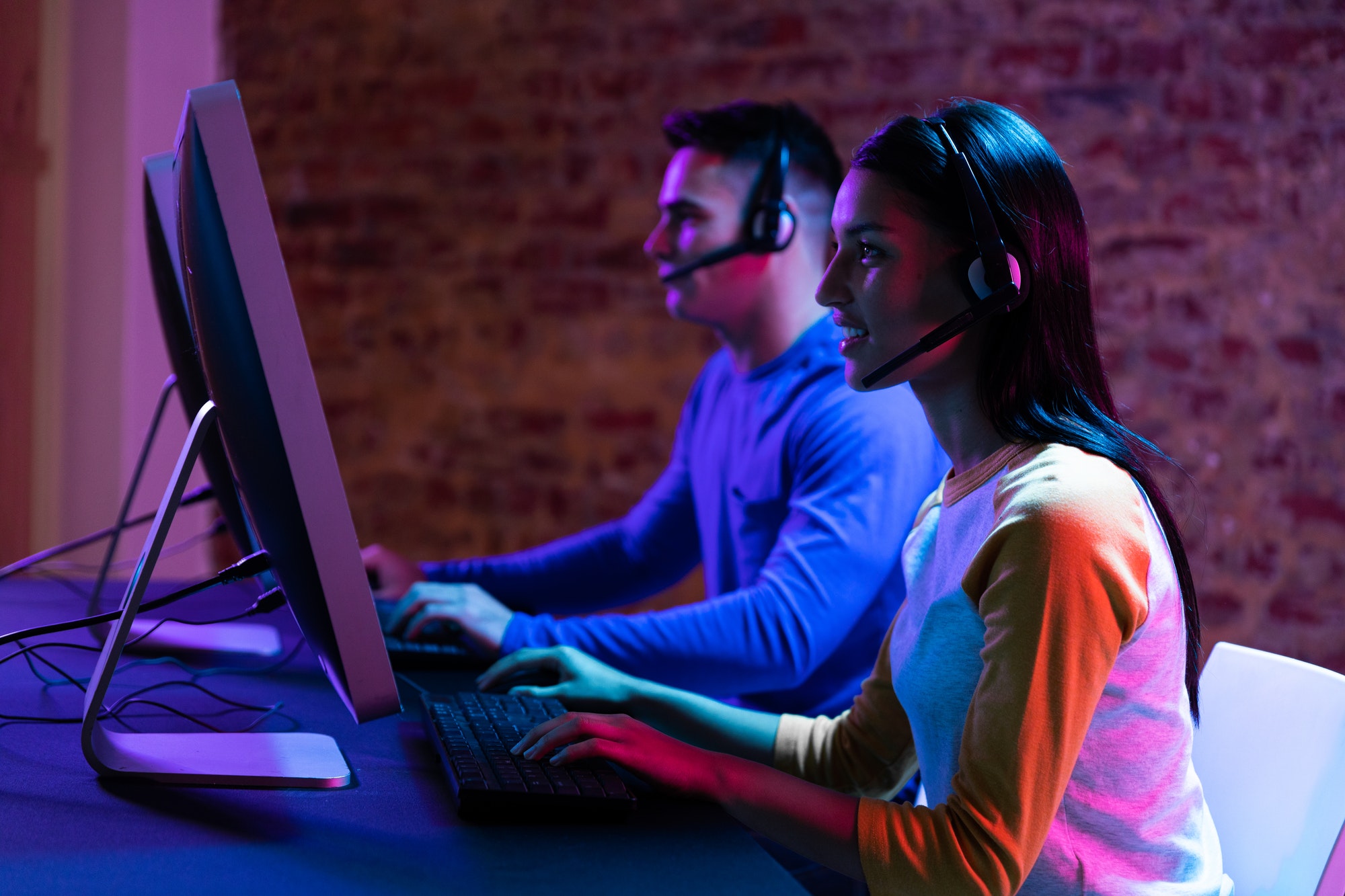 Caucasian man and a mixed race woman working late in a customer support office